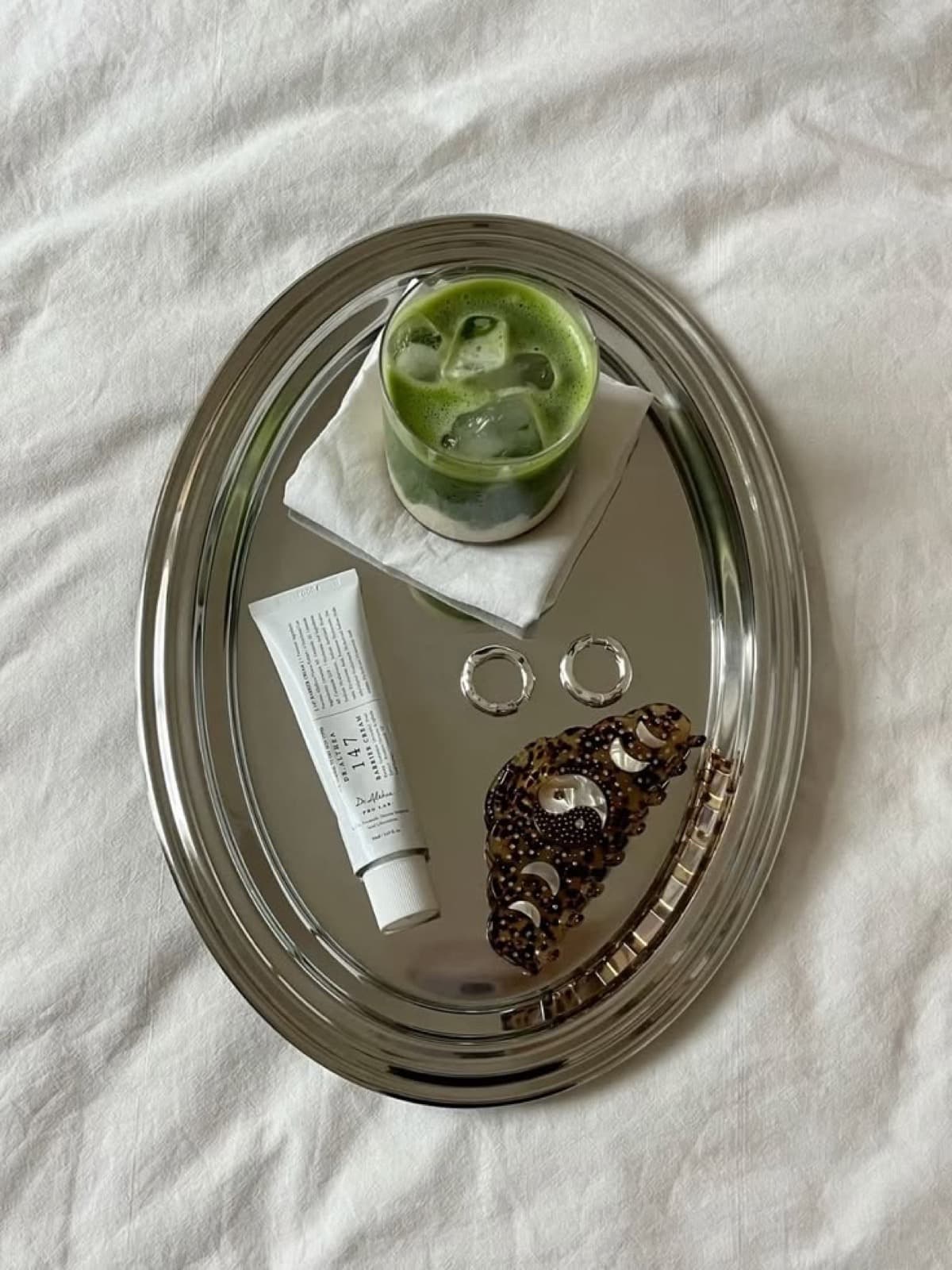 Matcha and skincare on a silver tray