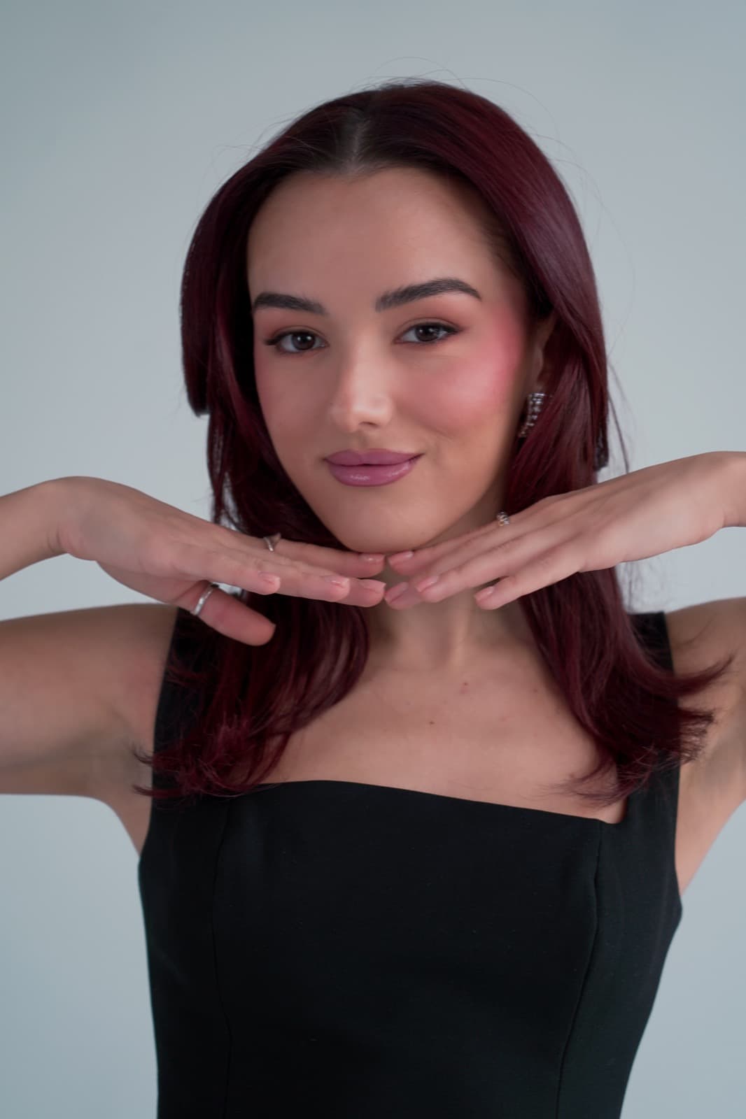 Portrait with hands framing her jaw